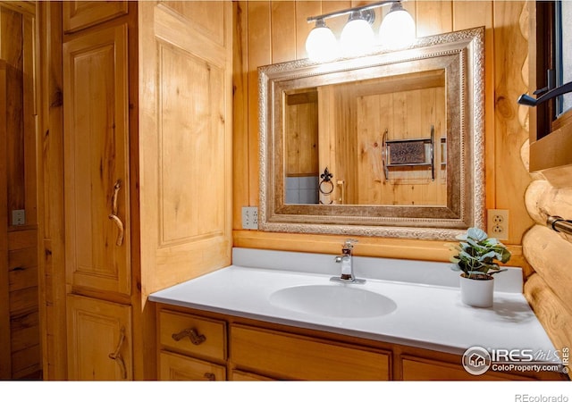 bathroom with vanity and wooden walls