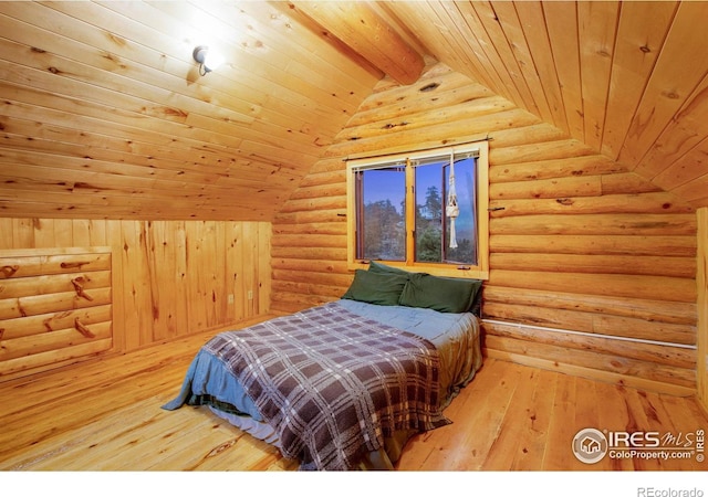 bedroom featuring rustic walls, vaulted ceiling with beams, wood ceiling, and wood-type flooring