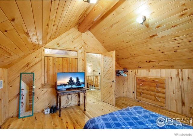 bedroom featuring vaulted ceiling with beams, wooden walls, wood-type flooring, and wooden ceiling