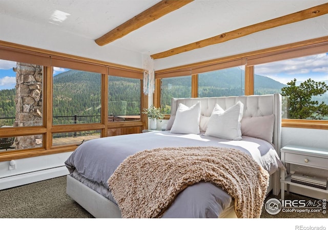 bedroom with beam ceiling, a baseboard radiator, and a mountain view