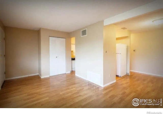 spare room with light hardwood / wood-style floors