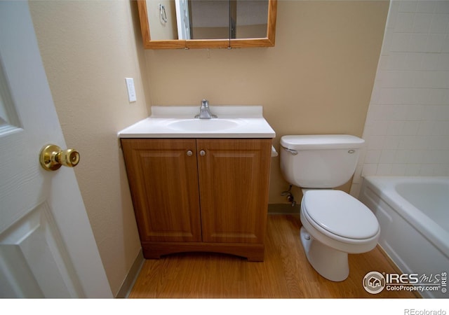 bathroom featuring wood-type flooring, vanity, and toilet