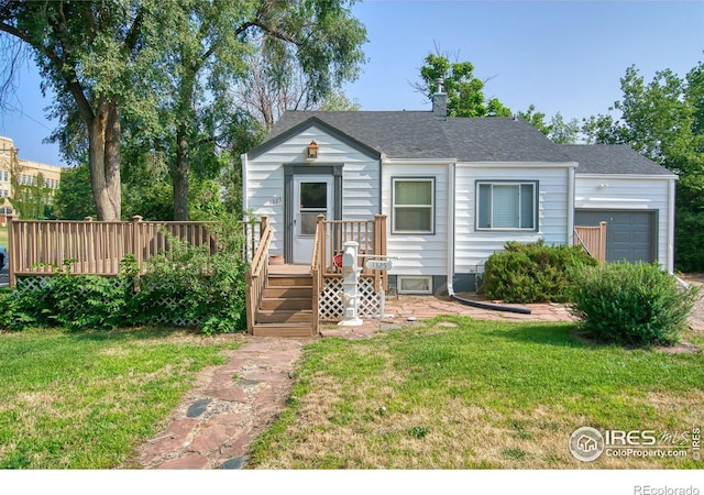 view of front of house with a garage, a wooden deck, and a front yard