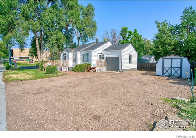 view of front of home featuring a garage and a storage shed