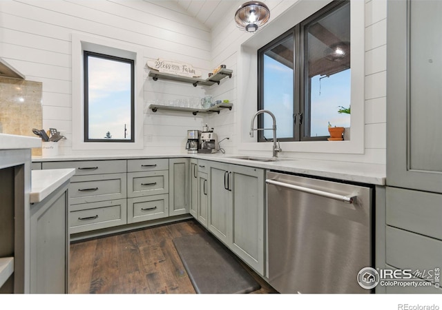 kitchen with sink, dark hardwood / wood-style flooring, a healthy amount of sunlight, and dishwasher