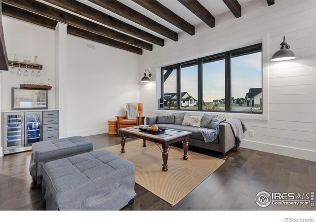 living room with beamed ceiling, beverage cooler, and dark wood-type flooring