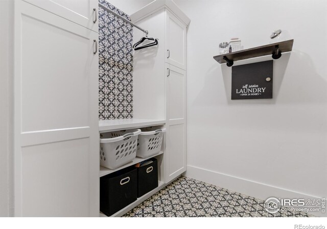 spacious closet with light tile patterned flooring