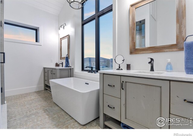 bathroom with tile patterned floors, vanity, and a wealth of natural light