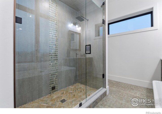 bathroom featuring a shower with shower door