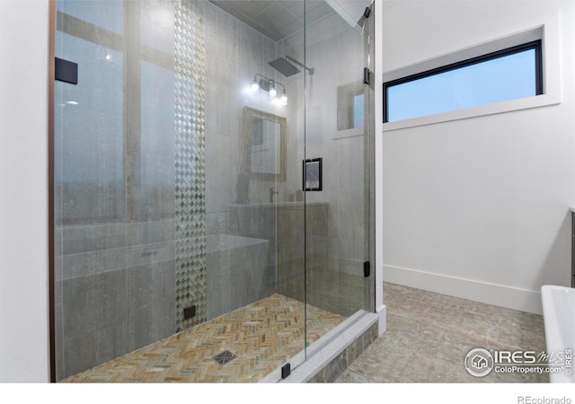 bathroom featuring a shower with door