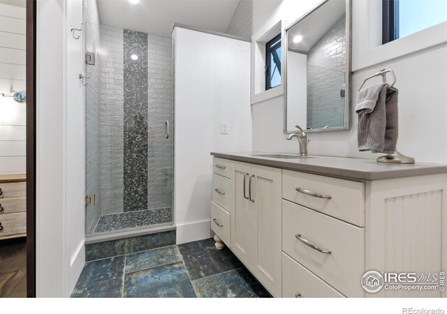 bathroom featuring vanity, a shower with door, and tile patterned flooring