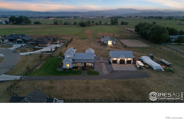 aerial view at dusk with a rural view and a mountain view