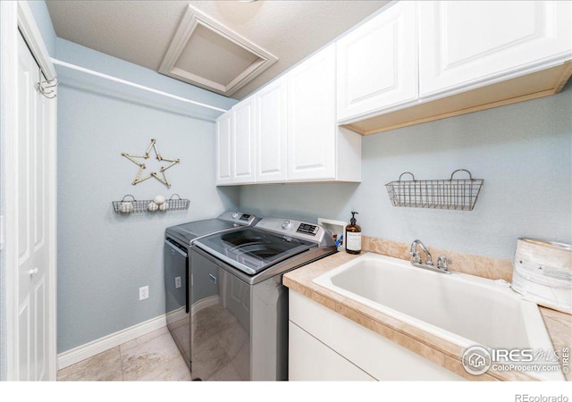 laundry room featuring sink, cabinets, and independent washer and dryer