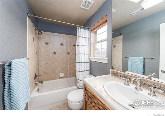 full bathroom with a textured ceiling, vanity, shower / tub combo with curtain, and toilet