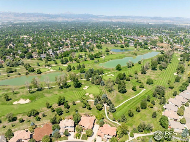 birds eye view of property with a water and mountain view