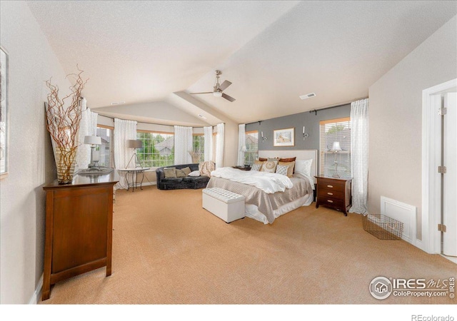 bedroom with light carpet and vaulted ceiling