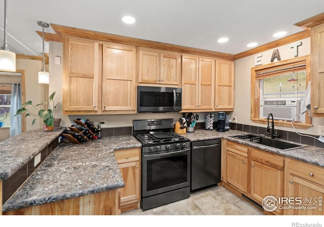 kitchen featuring sink, appliances with stainless steel finishes, hanging light fixtures, and a healthy amount of sunlight