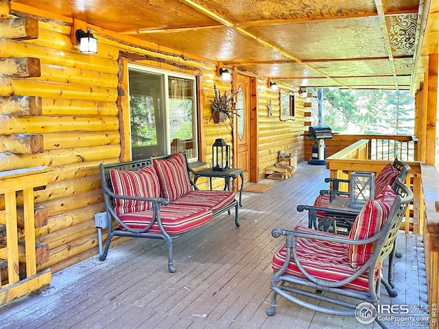 wooden terrace featuring a grill