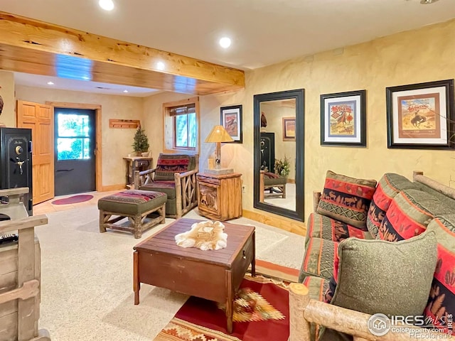 living room featuring light carpet and beamed ceiling