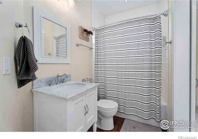 full bathroom with vanity, hardwood / wood-style floors, toilet, and shower / bath combination with curtain