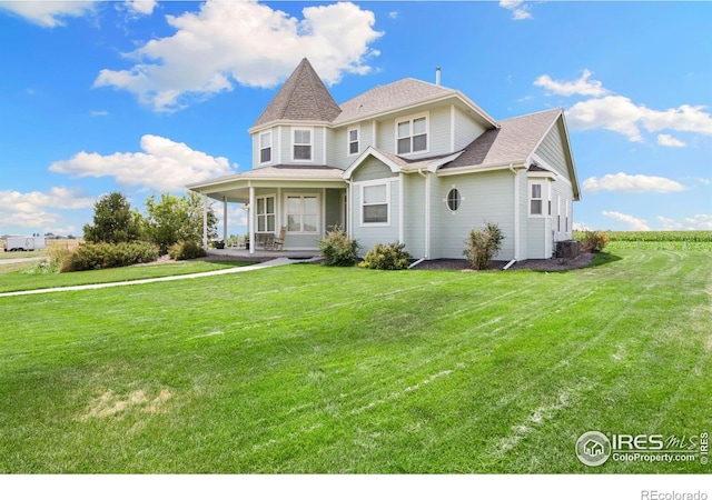 view of front of property with a front lawn and cooling unit