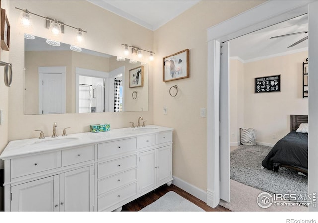 bathroom featuring dual vanity, crown molding, ceiling fan, and hardwood / wood-style floors