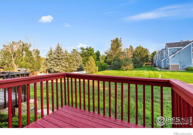 wooden deck with a lawn