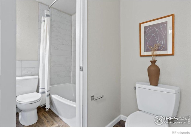 bathroom with toilet, hardwood / wood-style floors, and shower / bath combo with shower curtain