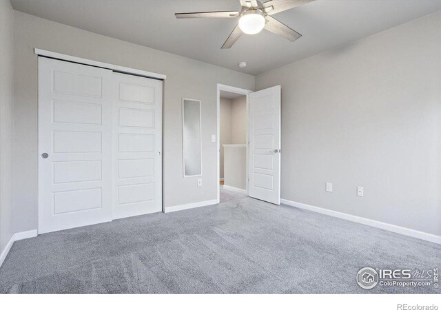 unfurnished bedroom featuring ceiling fan, carpet flooring, and a closet