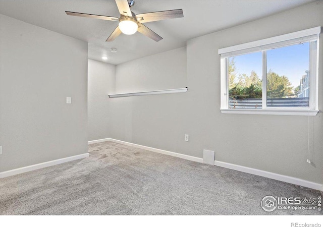 spare room featuring carpet and ceiling fan