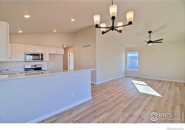 kitchen featuring white cabinetry, light hardwood / wood-style flooring, stainless steel appliances, and decorative light fixtures