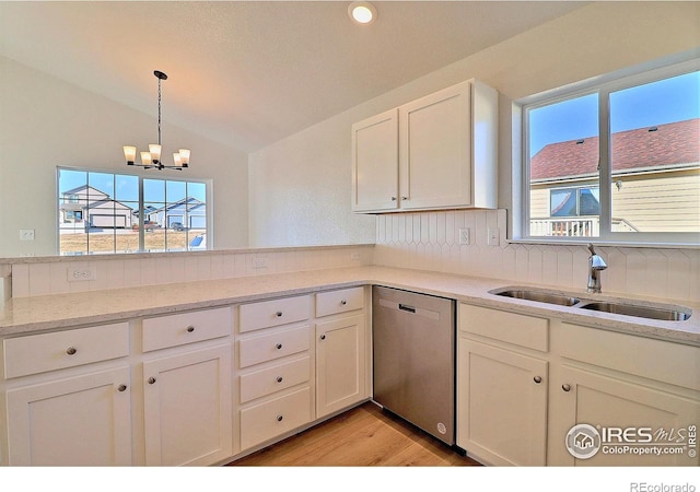 kitchen featuring vaulted ceiling, sink, light hardwood / wood-style flooring, dishwasher, and white cabinetry