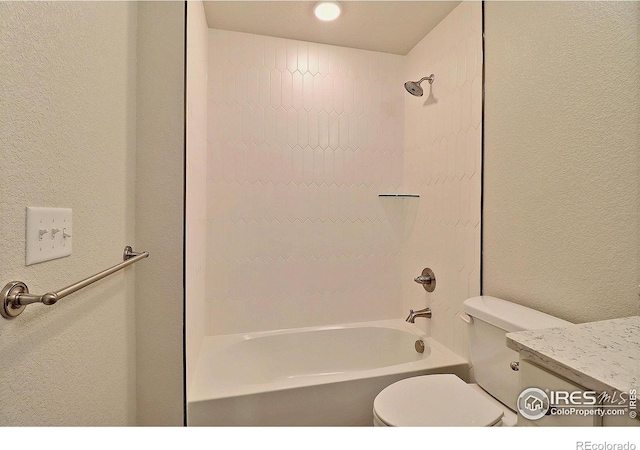 full bathroom featuring tiled shower / bath combo, toilet, and vanity