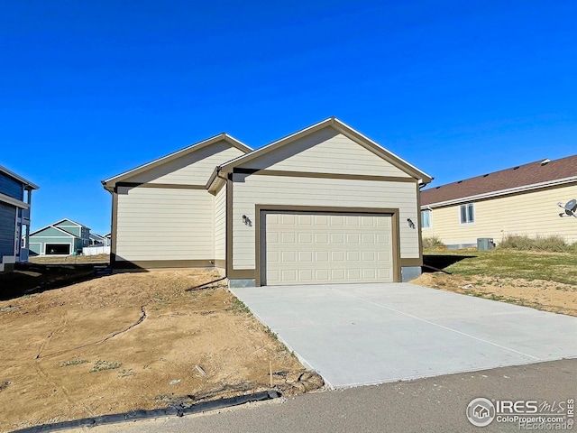 single story home featuring a garage and central AC unit