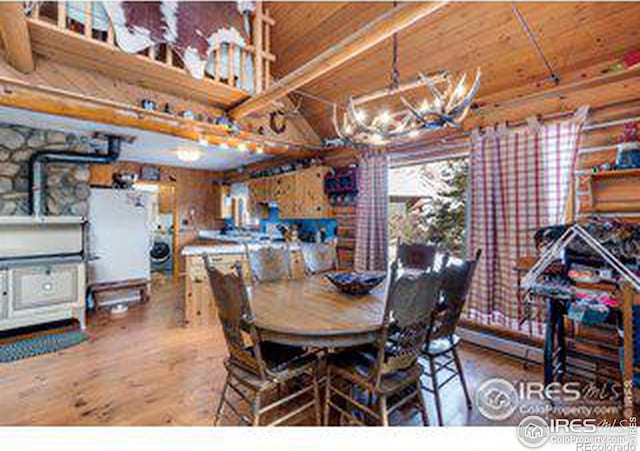 dining space featuring wooden ceiling, wood-type flooring, and a notable chandelier