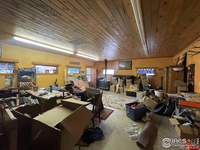 interior space featuring wooden ceiling and concrete flooring