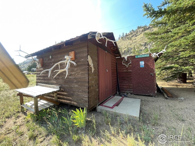 view of side of property featuring a storage shed