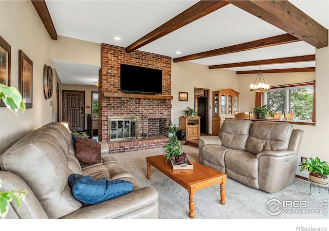 living room with a chandelier, brick wall, light carpet, beamed ceiling, and a brick fireplace