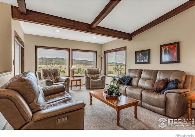 carpeted living room featuring a mountain view and beamed ceiling