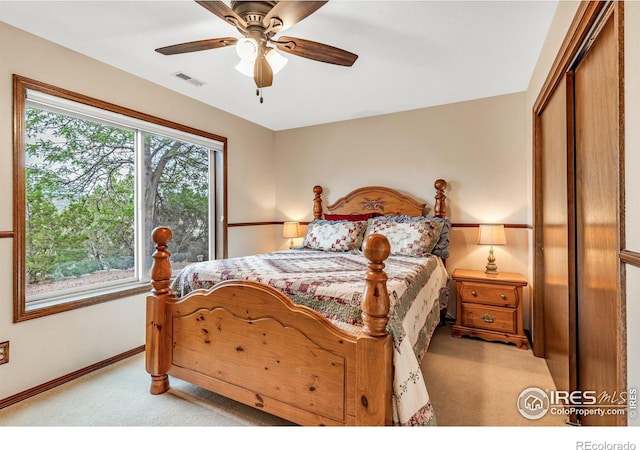 carpeted bedroom featuring a closet and ceiling fan