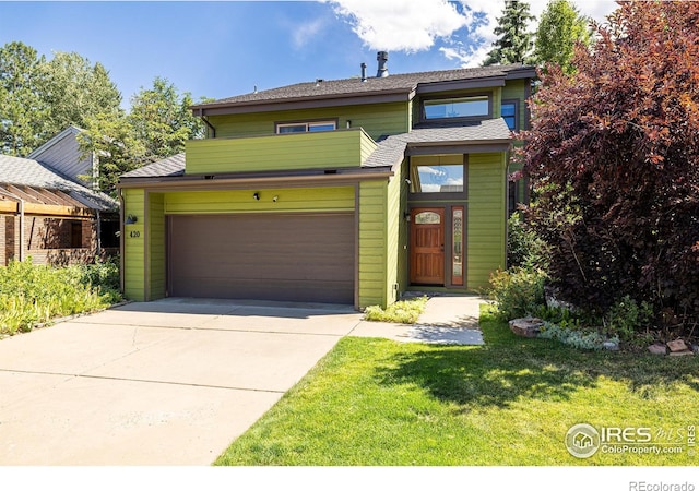 view of property with a front yard and a garage