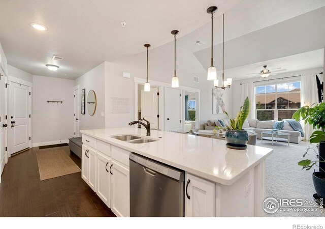 kitchen featuring stainless steel dishwasher, vaulted ceiling, sink, white cabinets, and hanging light fixtures