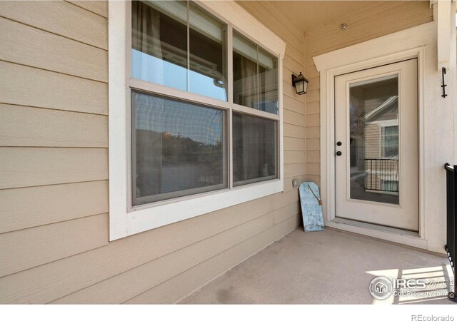 view of exterior entry featuring covered porch