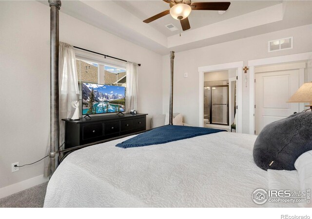 bedroom featuring carpet flooring, ceiling fan, and a raised ceiling