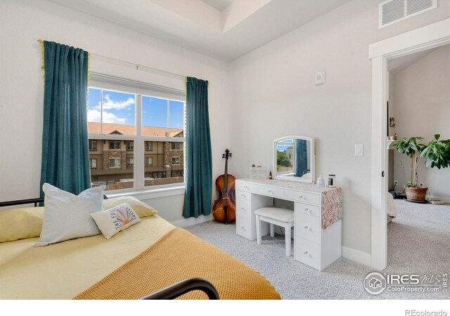 bedroom featuring light carpet, visible vents, and baseboards