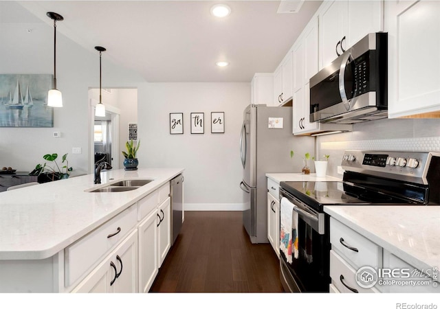 kitchen featuring dark hardwood / wood-style floors, light stone countertops, sink, and appliances with stainless steel finishes