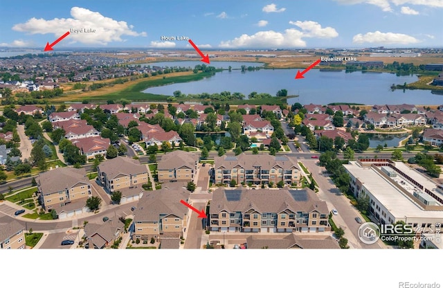 birds eye view of property with a residential view and a water view