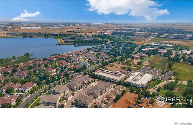 drone / aerial view featuring a residential view and a water view