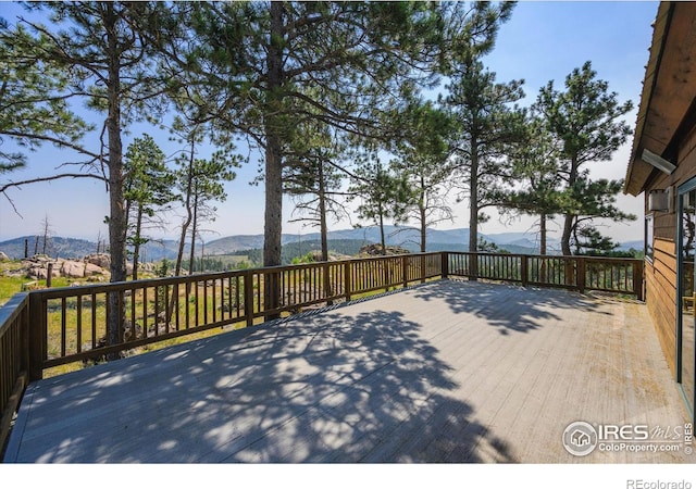 wooden deck featuring a mountain view