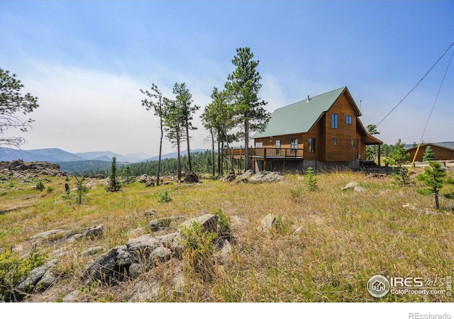 view of yard featuring a deck with mountain view